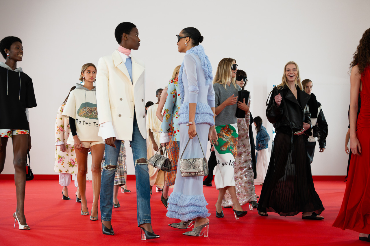 Guests and models mingling on the red carpet after the show.