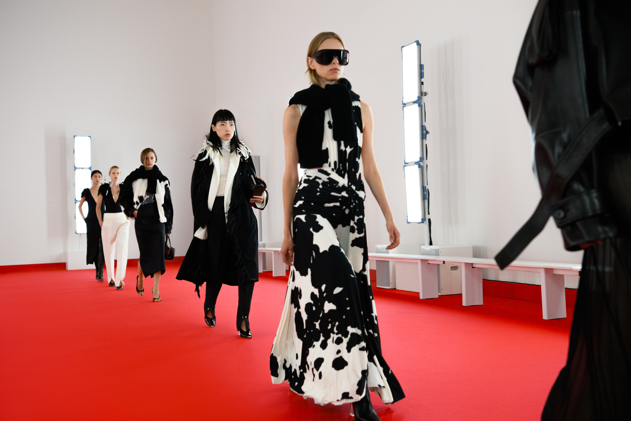 Models walking the runway in black and white cow-print and monochrome looks at the Brandon Maxwell SS25 show.