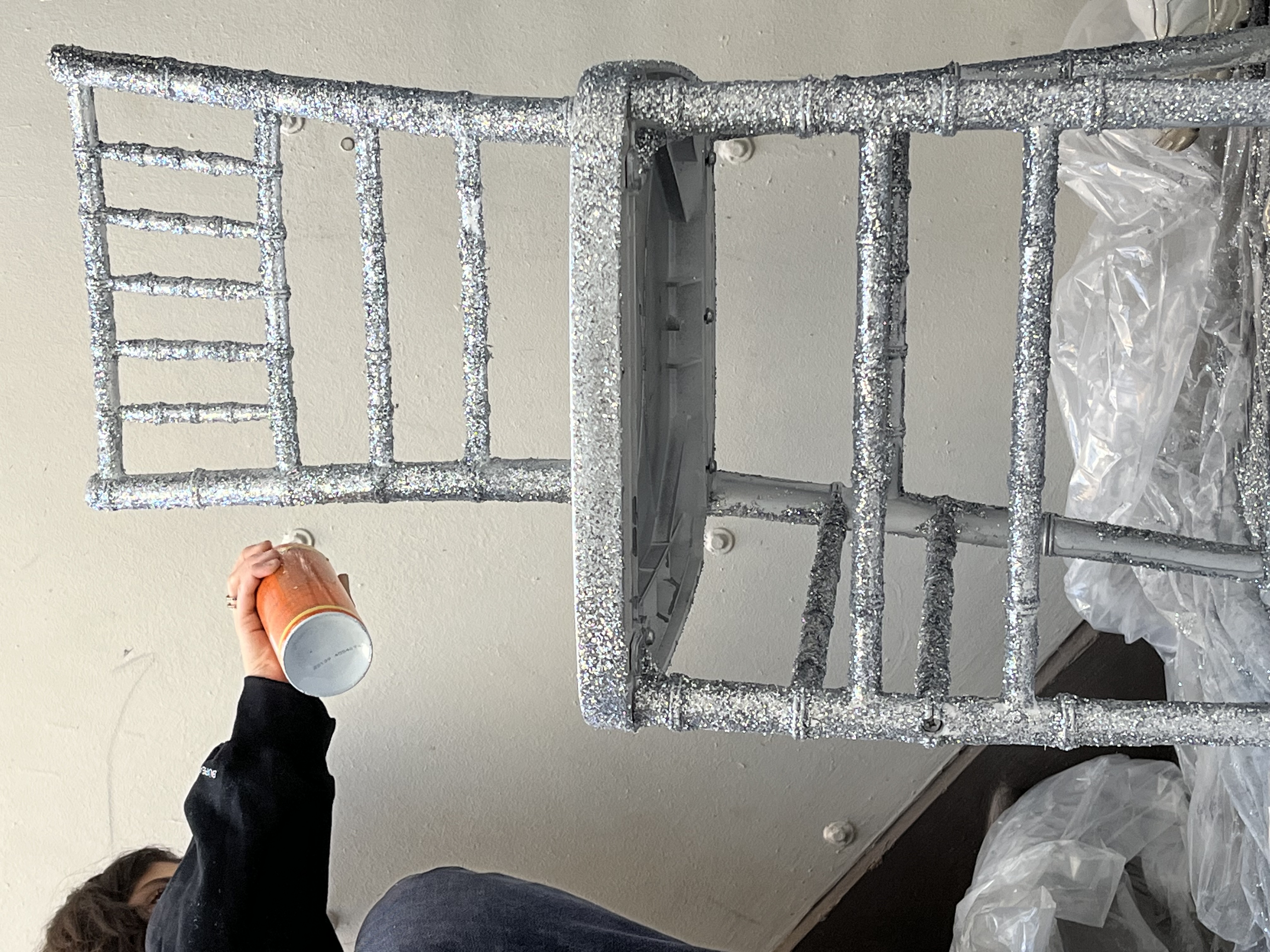 Close-up of a fully glittered chair frame during production.