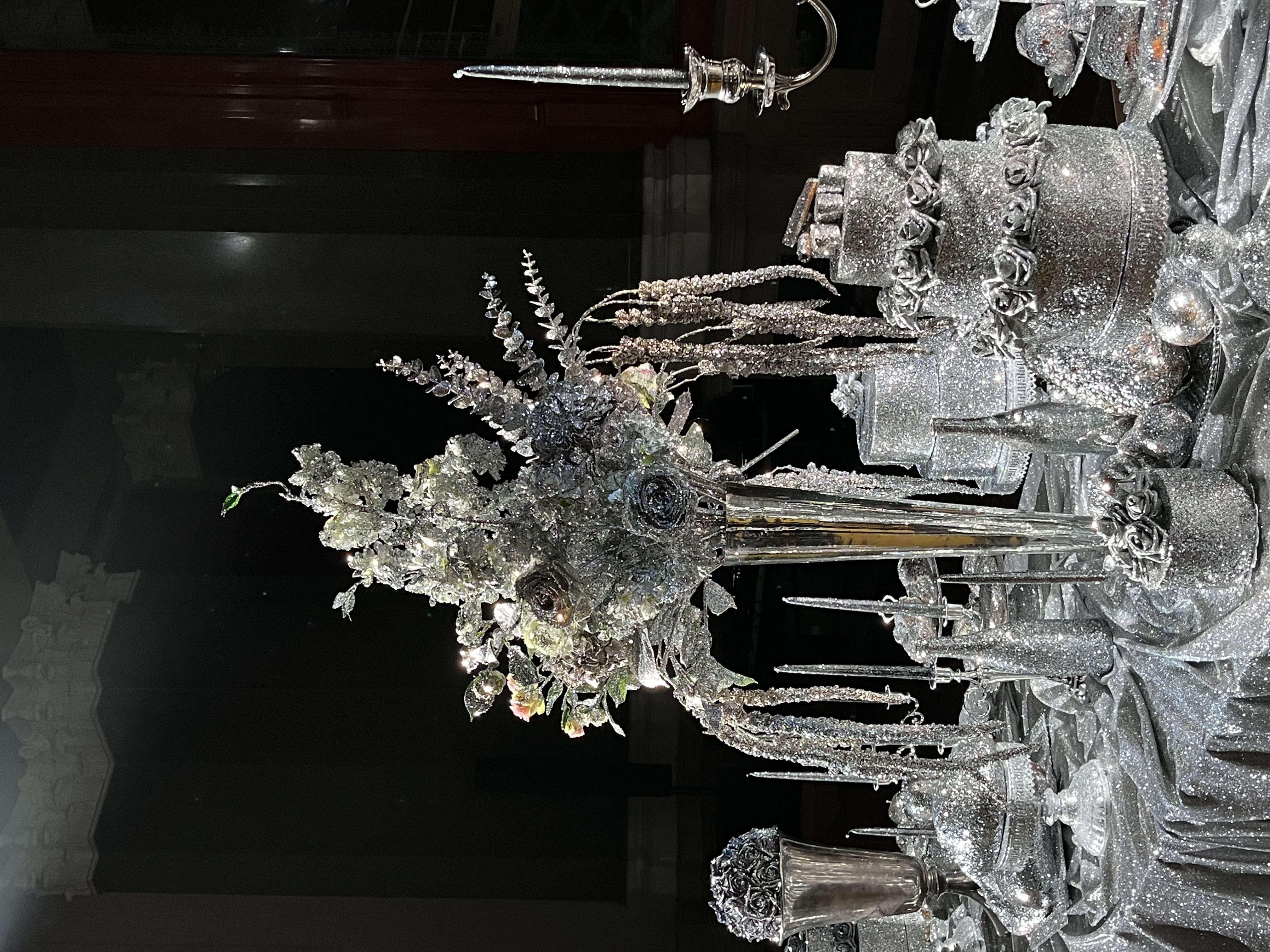 Close-up of the finished silver floral centerpiece and candelabra at the show.