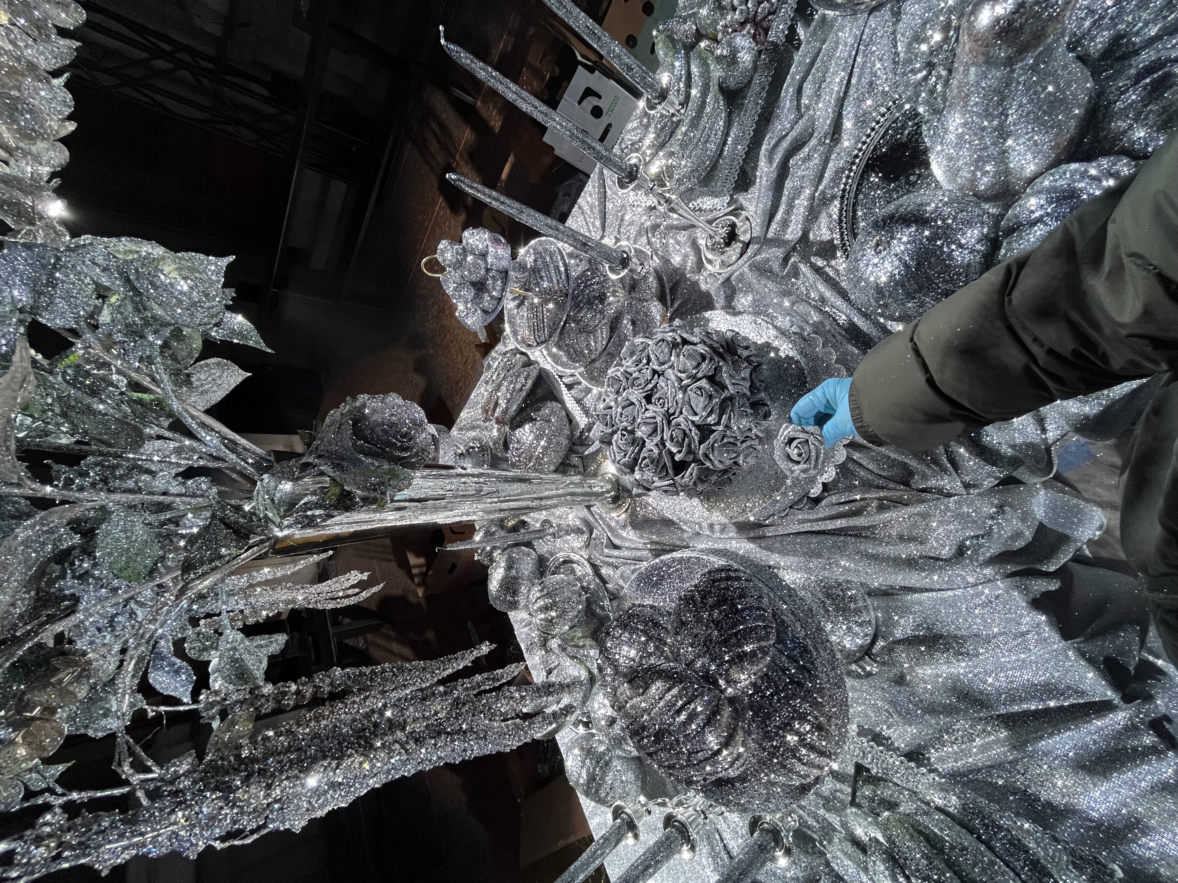 Close-up of glittered floral and candelabra details being assembled for the tablescape.