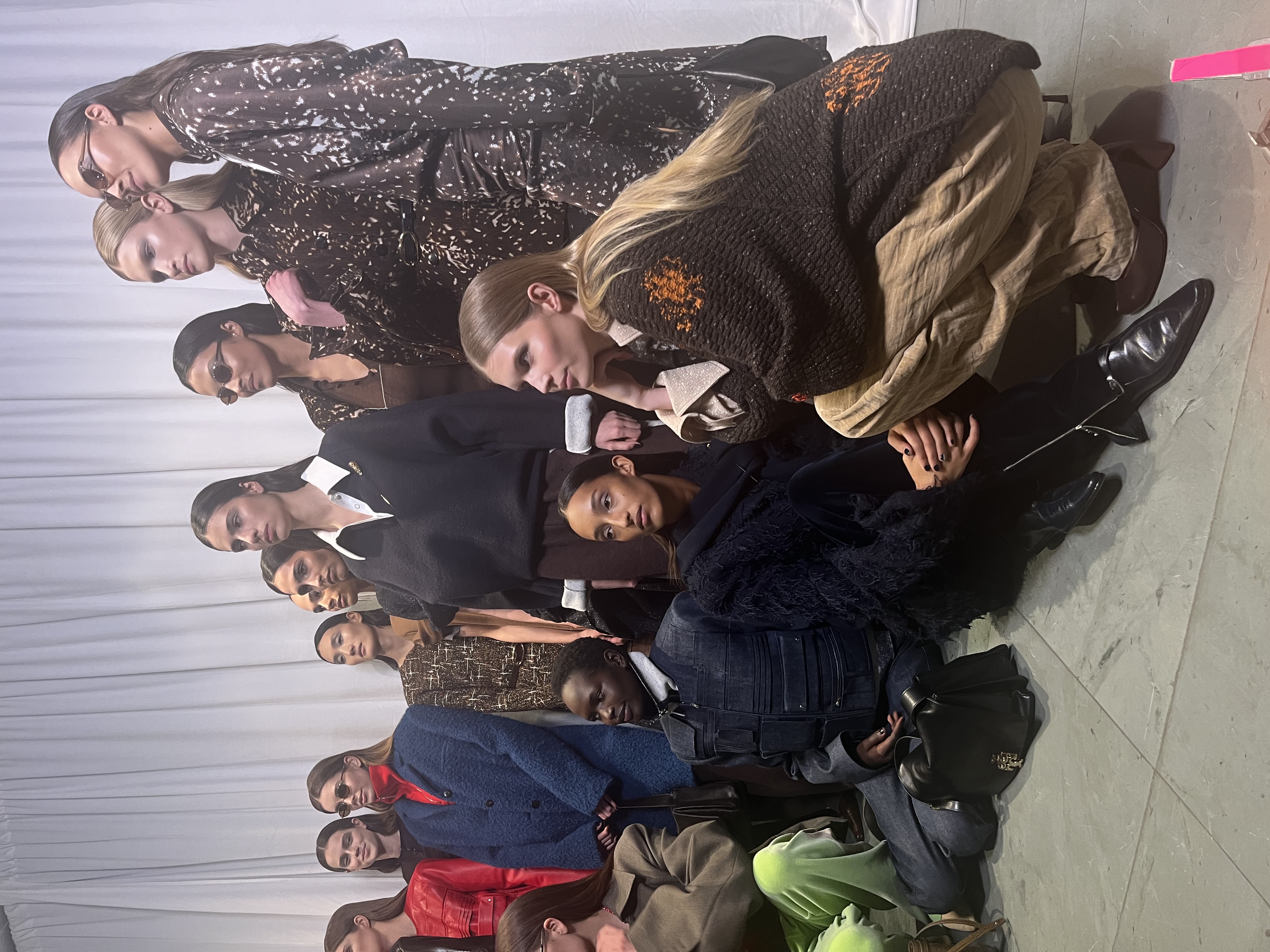 Group of models backstage lined up in Fall/Winter 25 looks before the show.